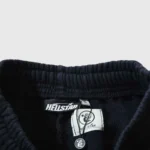 Close-up view of the elastic waistband and brand tag on the black Hellstar Fire Elastic Sweatpants for men and women.