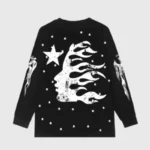 Black Hellstar long sleeve t-shirt featuring a white flaming face graphic, star designs, and distressed print details.