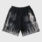 Black Hellstar flame shorts featuring signature white graphic print designs on both legs for a bold streetwear look.