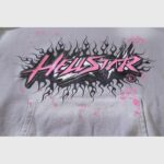 Close up of the Hellstar Future Flame Hoodie featuring a grey fabric with pink and black flame graphic screen print.