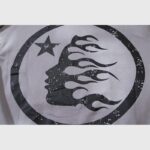 Close-up graphic print on the grey Hellstar Future Flame Hoodie featuring a black silhouette face with flame details
