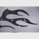 Close-up of the black flame graphic print detail on the grey Hellstar Future Flame hoodie streetwear fabric.