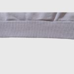 Close-up view of the ribbed fabric hem detail on a Hellstar Future Flame hoodie, showing quality construction.
