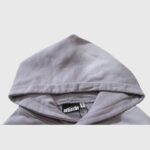 Close-up view of the grey Hellstar Future Flame Hoodie featuring the brand neck label and quality fabric details.
