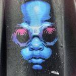 Hellstar Goggles T-Shirt in black featuring a futuristic blue face graphic with oversized goggles and signature branding.