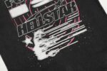 The Hellstar Goggles T-Shirt features a detailed black graphic design with futuristic sci-fi motifs and branding.