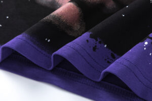 Close-up view of the purple hem detail and galaxy print fabric on a Hellstar Goggles T-Shirt for premium streetwear.