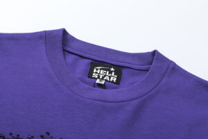 Close up of the purple Hellstar Goggles T-shirt neck label showing the authentic brand tag on premium cotton fabric.