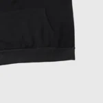 Close-up view showing the hem and front pocket detail of the black Hellstar Graffiti Print cotton-blend fleece hoodie.