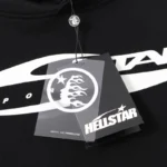 Hellstar black graffiti print hoodie featuring brand tag detail with the Path to Paradise logo and lettering design.
