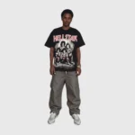 A male model wearing a black Hellstar graphic tee made from premium soft cotton with a crew neck and screen print.