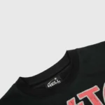 Close-up view of the interior neck label on the black Hellstar graphic tee, showing the branding and stitching detail.
