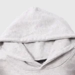 Close-up view of a Hellstar gray hoodie showing the premium fabric and hood detail from their graphic print tracksuit.