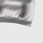 Close-up view of the front kangaroo pocket on a gray Hellstar graphic print designer streetwear cotton hoodie.