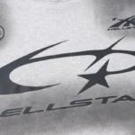 Close-up of the Hellstar gray graphic print tracksuit featuring iconic bold lettering and black star branding details.