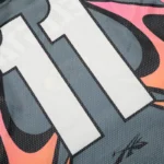 Close-up view of the Hellstar grey and orange mesh long sleeve tee showing the graphic print and mesh fabric detail.