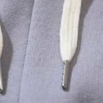 Close-up view of the adjustable drawstring and silver hardware detail on the Hellstar Grey Future Flame sweatpants.