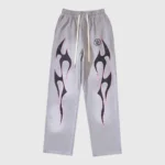 Front view of the Hellstar Grey Future Flame sweatpants featuring large black and pink flame graphic prints on legs.
