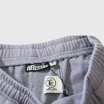 Close-up of the Hellstar Grey Future Flame Sweatpants interior label and branding details on premium grey fleece fabric.