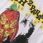 Close up of the Hellstar Halloween 1996 P2P white t-shirt featuring a flaming pumpkin, a spider, and cat graphics.