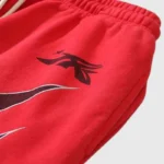 Close-up detail of the bright red Hellstar Halloween Flame sweatpants featuring a stylized black flame graphic print.