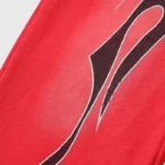 Close-up view of the Hellstar Halloween Flame sweatpants showing the detailed black flame graphic on red fabric.
