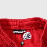 Close-up view of the interior brand and authentication label on red Hellstar Halloween Flame designer sweatpants.