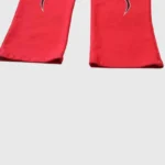 Close-up view of the red Hellstar Halloween Flame Sweatpants showcasing the leg detail and iconic flame graphic design.