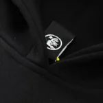 Close-up view of the branded logo tag on the black Hellstar Halloween Skeleton Print Hoodie sweatshirt