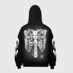 Back view of a black Hellstar Halloween hoodie featuring a prominent white skeleton rib cage graphic on the back.