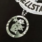 Close-up detail of the Hellstar Hand Prayer graphic screen print on a premium black cotton streetwear t-shirt.