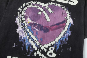 Close-up of the Hellstar Heroes Villains tee featuring a detailed graphic purple heart design on a black cotton shirt.