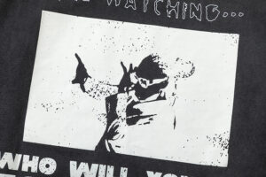 Close-up view of the white screen-printed graphic detail on the black Hellstar Heroes Villains T-shirt apparel.