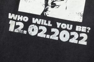 Close-up of the Hellstar Heroes Villains t-shirt featuring the graphic text Who Will You Be and the date 12.02.2022.