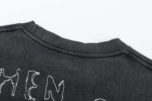 Close-up view of the ribbed neckline on the premium black cotton Hellstar Heroes Villains graphic t-shirt.
