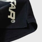 Close-up view of the black Hellstar Hstar shorts featuring the signature white graphic logo screen print design.