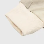 Close up of the ribbed knit cuff detail on the cream colored Hellstar HStar Records streetwear cotton hoodie.