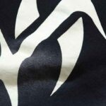 Close-up view of the premium black Hellstar Hstar shorts fabric featuring the iconic white graphic screen print design.