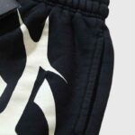 Close up view of the black Hellstar Hstar shorts featuring a signature white screen printed logo graphic on the fabric.