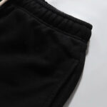 A detailed close-up shot of the premium black cotton fabric and elastic waistband on Hellstar tracksuit pants.