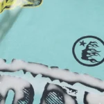 Close-up detail of the light blue Hellstar Human Skeleton T-Shirt showing the high-quality screen printed graphic logo.