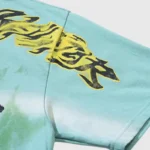 Close-up view of the bold black and yellow graphic print on a light blue Hellstar Human Skeleton cotton t-shirt.