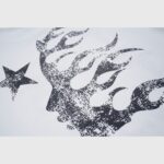 Close-up view of the Hellstar I Love LA T-shirt graphic featuring a black distressed flame face silhouette and star.