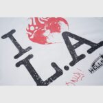 Hellstar I Love LA T-shirt graphic featuring a distressed burning heart icon and Lovers Only typography on white fabric.