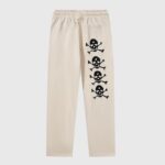 Hellstar If You Don’t Like Us Beat Us sweatpants in cream with black skull and crossbones back graphic print.
