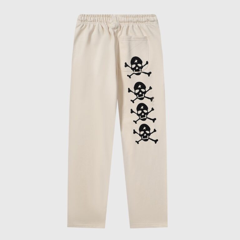 Hellstar If You Don’t Like Us Beat Us sweatpants in cream with black skull and crossbones back graphic print.
