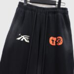 Black Hellstar If You Don’t Like Us Beat Us tracksuit sweatpants with orange and white logo graphic prints.