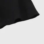 Close-up view of the premium black cotton fabric texture on a Hellstar Inner Peace graphic t-shirt sleeve.
