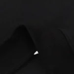 Close-up view of the premium, soft black fleece fabric on the Hellstar Inner Peace Fire Hoodie sweatshirt.