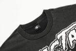 Close-up view of the ribbed neckline and branded label on the vintage washed black Hellstar Inner Peace cotton T-shirt.
